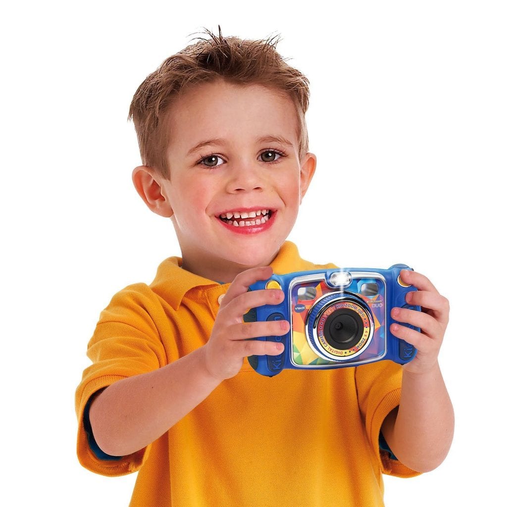Little boy loving his new camera to take pictures on the next trip. 