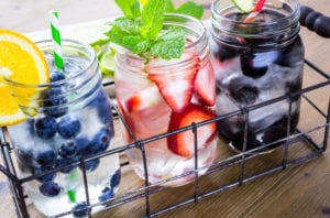 A few glasses with blueberries, strawberries and water a great way to flavor water for the whole family to drink. 