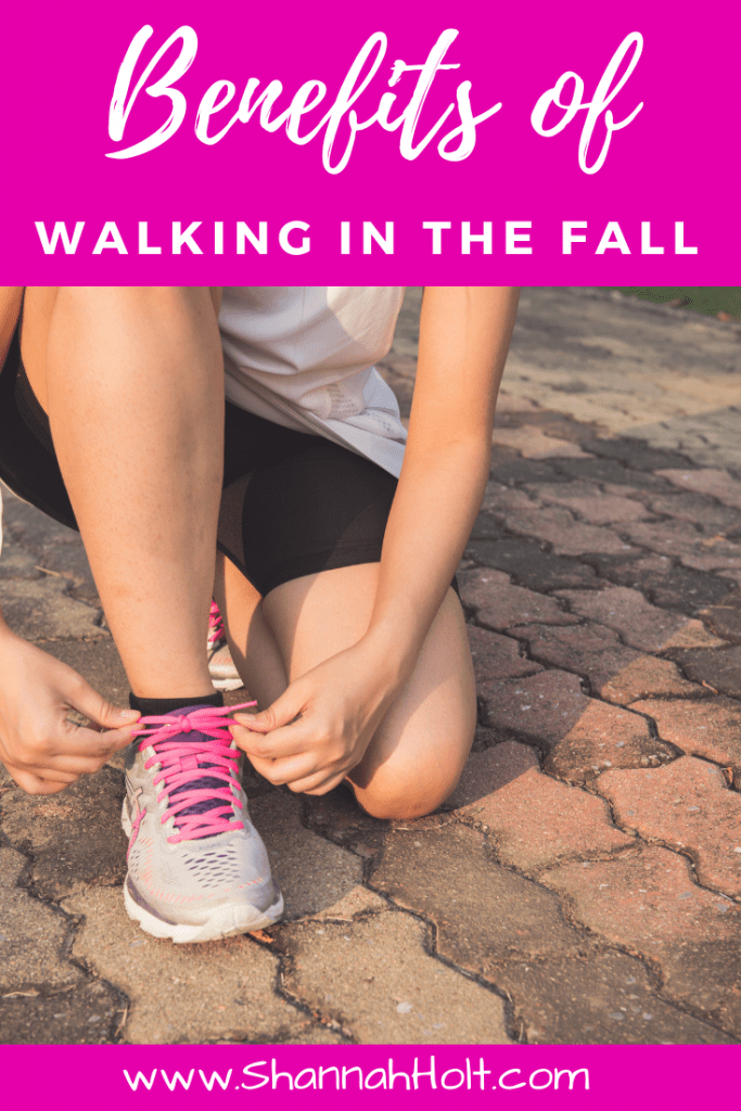 Woman tying her shoes to get all the benefits of walking in the fall. 