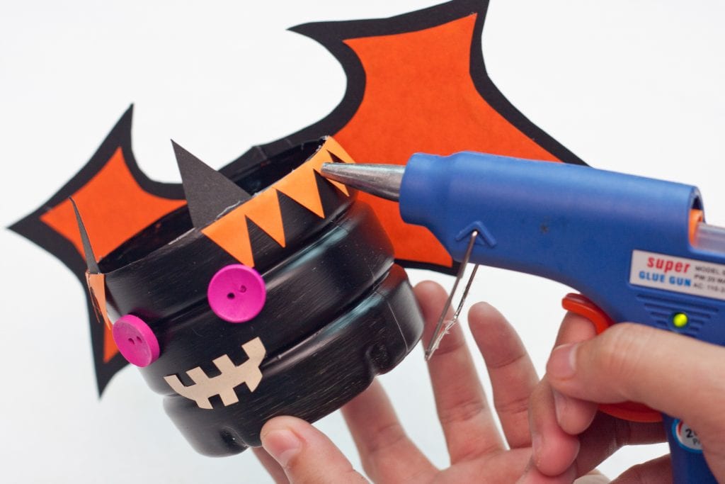 Halloween DIY Craft: Trick or Treat Basket Step 13 Cut and glue trim to the bat body.