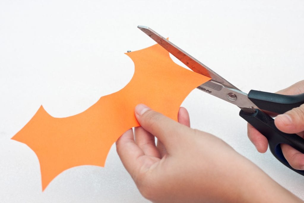 Halloween DIY Craft: Trick or Treat Basket Step 5 cut a bat wing from orange construction paper. 