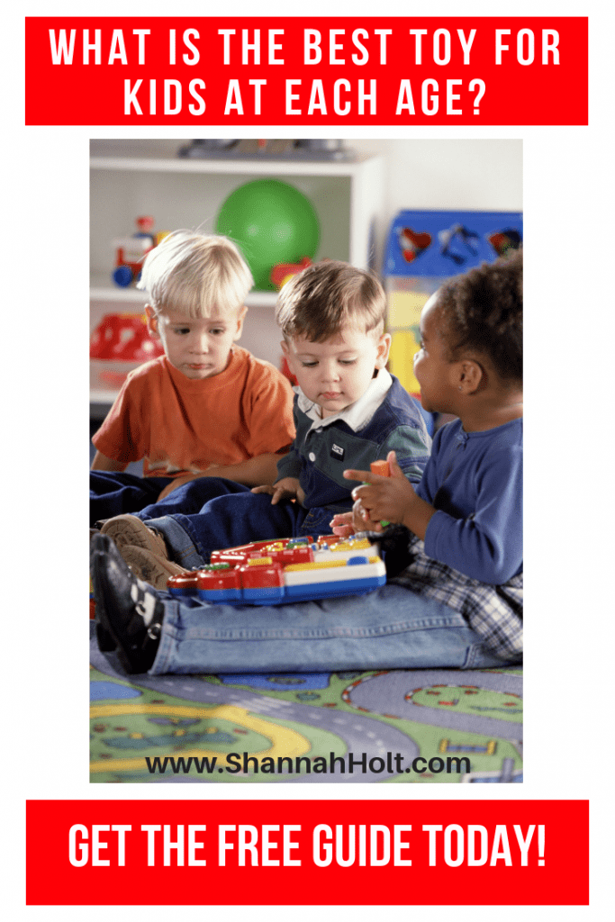 Three children sitting on a carpet in a playroom while one holds a toy and the others are watching with text WHAT ARE THE BEST TOYS FOR KIDS AT EACH AGE? Get the free guide. 