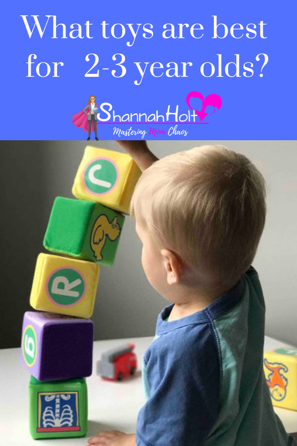 Boy building blocks with text box what toys are best for 2-3 year olds?