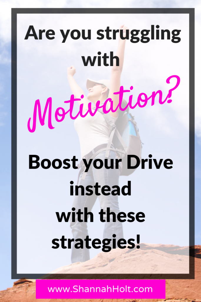 Woman at the top of the mountain reaching her goals. Are you struggling with motivation? Boost your drive instead with these strategies! 