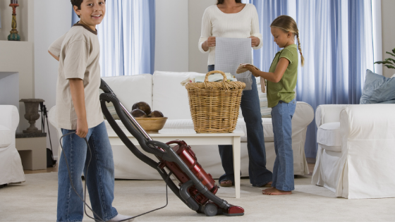 Family cleaning the livingroom together.